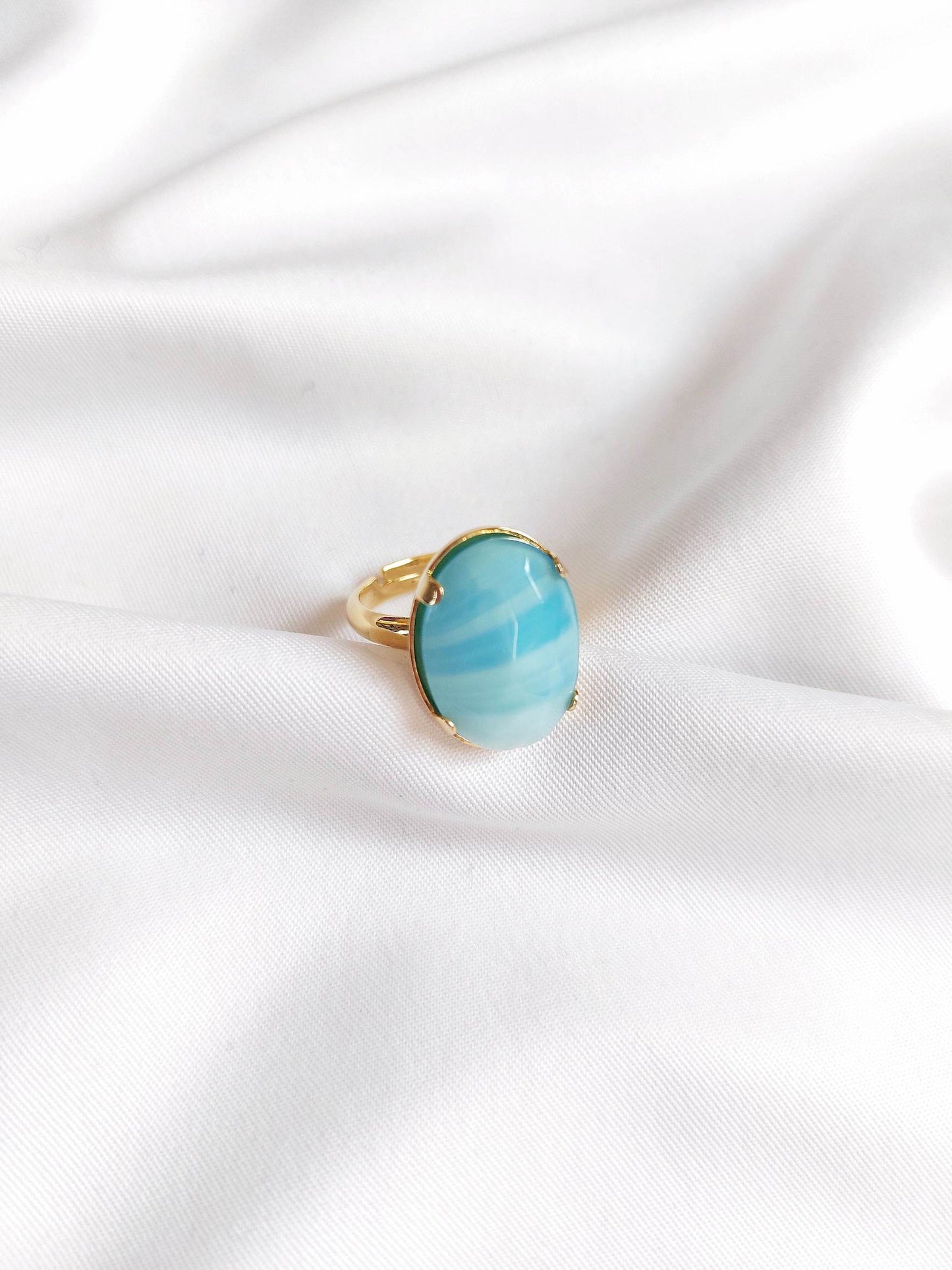 Adjustable gold ring with blue cabochon