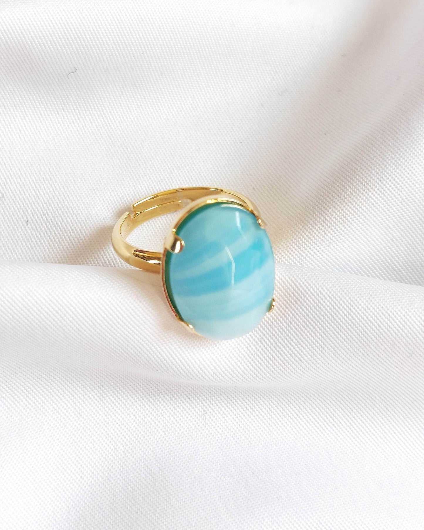 Adjustable gold ring with blue cabochon
