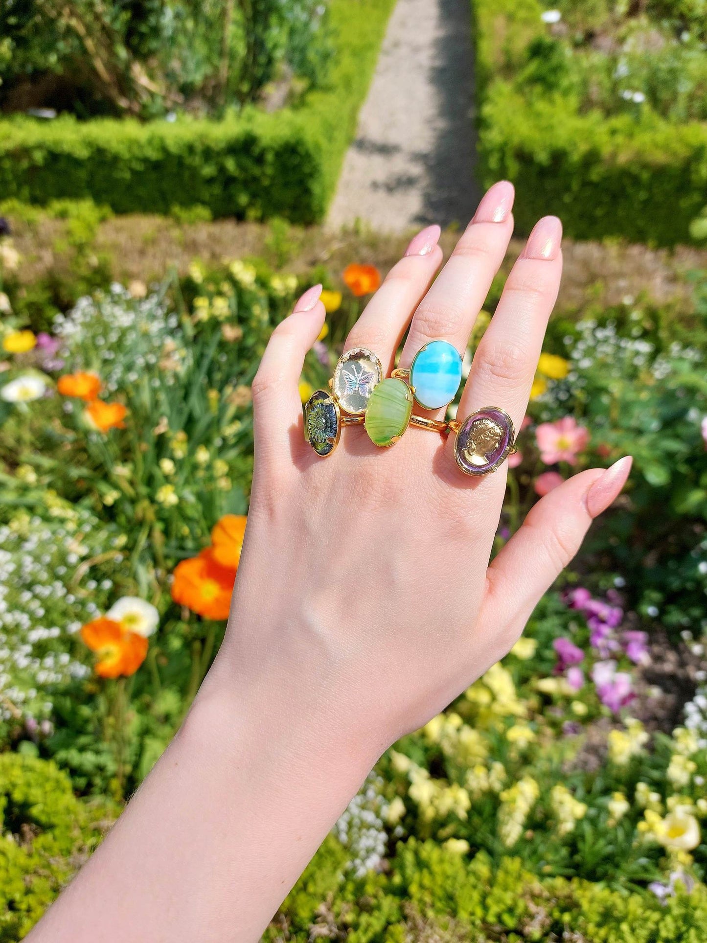 Adjustable gold ring with blue cabochon