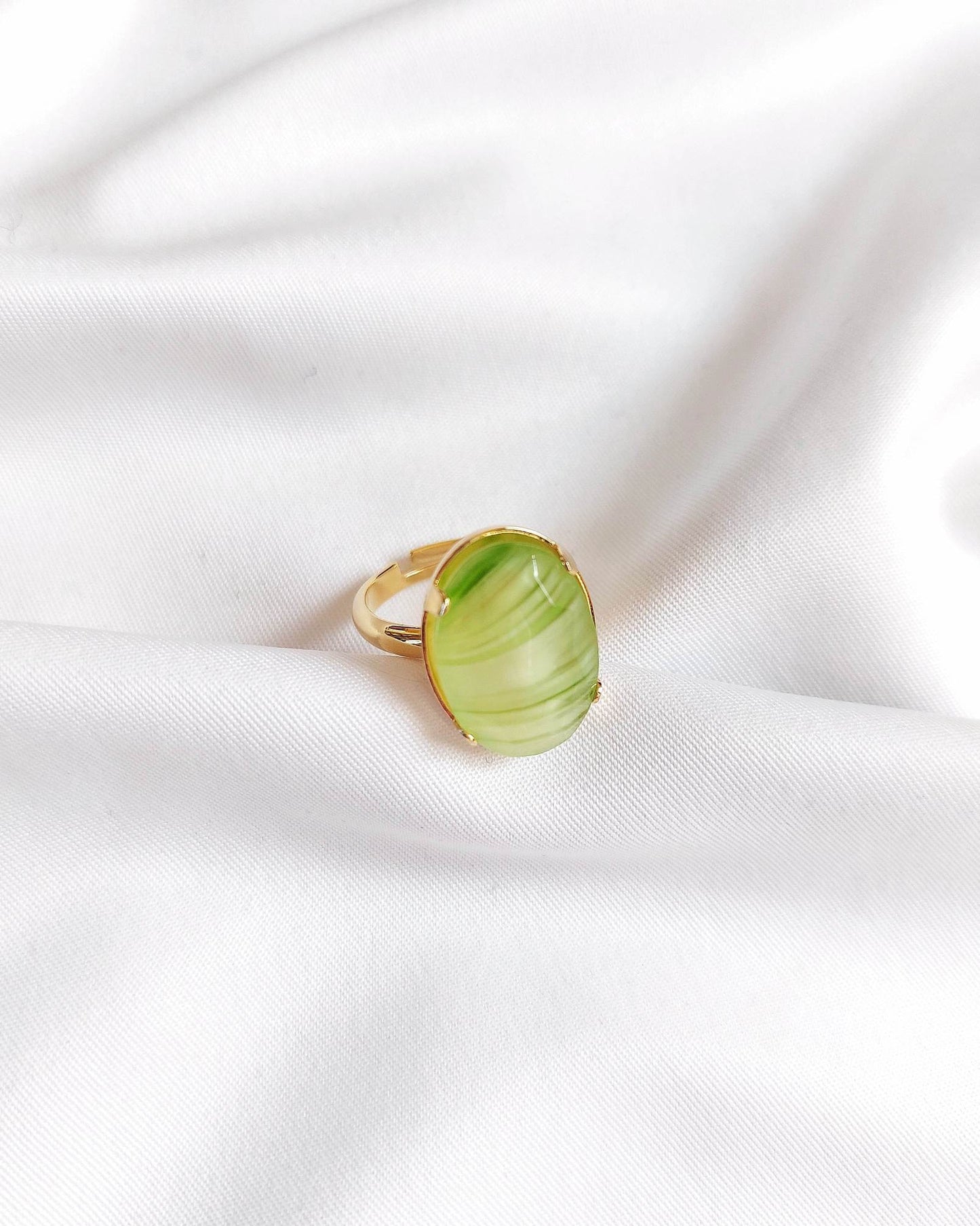 Adjustable gold-plated ring with green cabochon